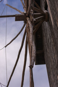 Low angle view of wood against sky