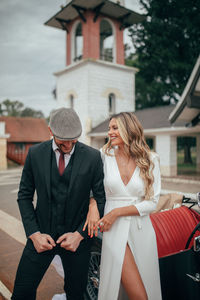 Full length of woman sitting outside building