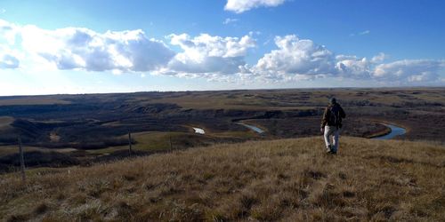 Rear view of man on land against sky