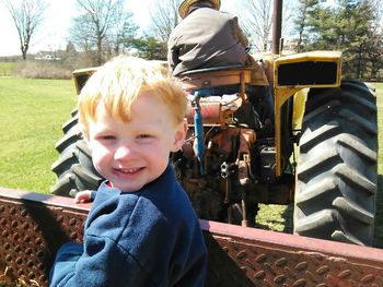 Boy looking away while standing on white background