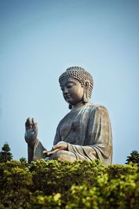 Low angle view of statue against sky