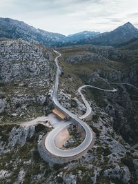 Aerial view of winding road on mountain against sky