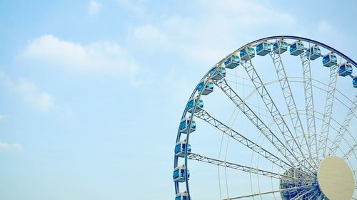 Low angle view of ferris wheel against sky