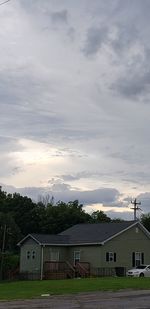 Houses and buildings against sky during sunset