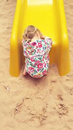 Girl playing on sand at beach