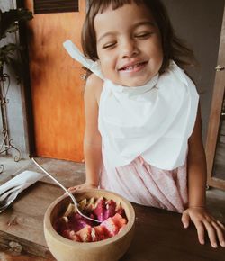 Cute girl holding ice cream at home