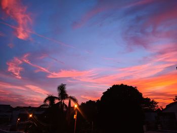 Silhouette trees against sky during sunset