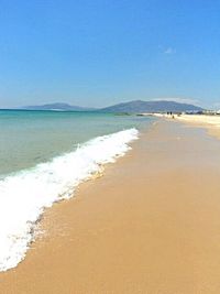 Scenic view of sea against blue sky