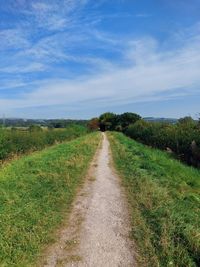 Empty road along countryside landscape