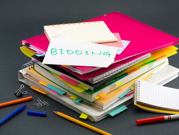 High angle view of text on paper over books on table