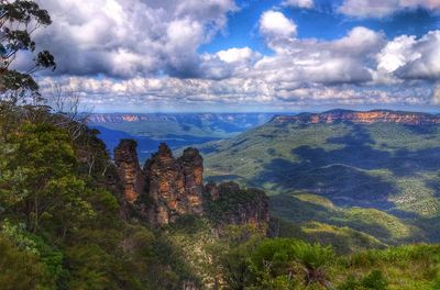 Scenic view of mountains against cloudy sky