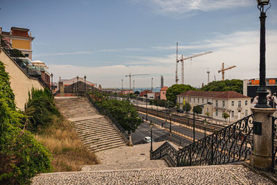 Footpath amidst buildings against sky