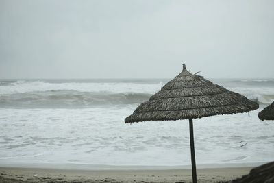 Lifeguard hut on beach against clear sky