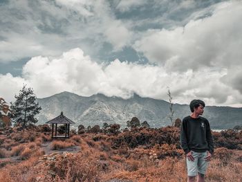 Man standing on mountain against sky