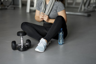 Low section of woman sitting on floor