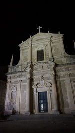 Low angle view of illuminated building against sky at night