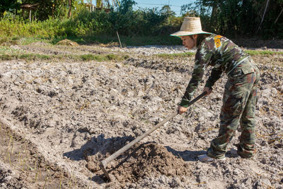 Full length of woman working in farm