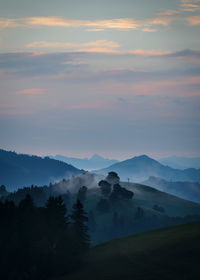 Scenic view of mountains against sky at sunset