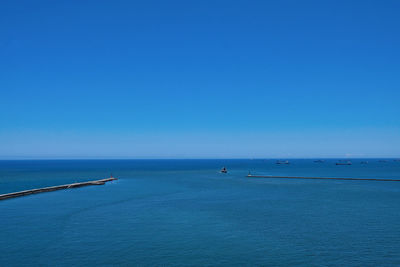 Scenic view of sea against clear blue sky