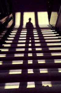 Shadow of person walking on staircase