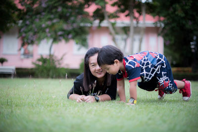 Portrait of young woman playing in lawn