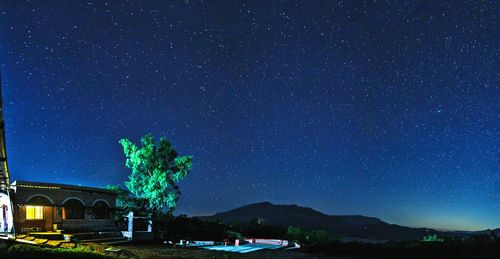 Scenic view of illuminated mountain against sky at night