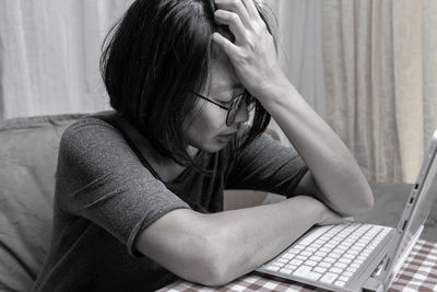 Midsection of woman using mobile phone at home