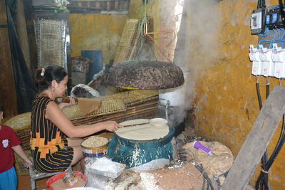 Side view of man preparing food in workshop