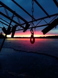 Silhouette of swing at sunset