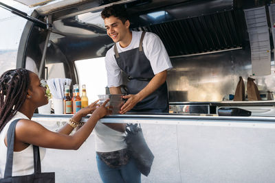 Young man working in front of woman