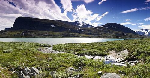 Scenic view of mountains against cloudy sky