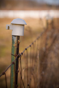 Close-up of wooden post on field