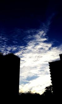 Low angle view of silhouette built structure against sky at sunset