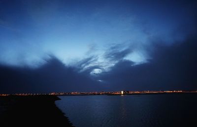 Scenic view of river against sky at dusk