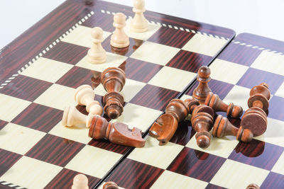 High angle view of chess board over white background