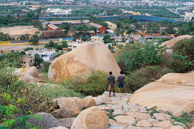 Rear view of people walking on rocks