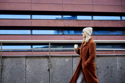 Woman at city street with coffee cup