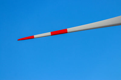 Low angle view of flag against clear blue sky