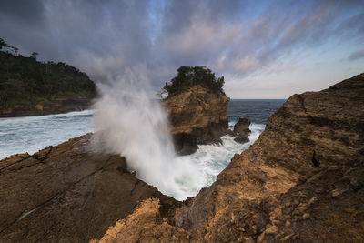 Scenic view of sea and rocks against sky