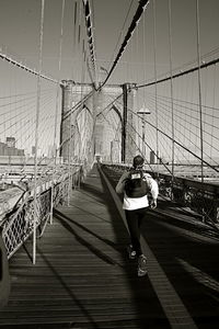 Rear view of man running on brooklyn bridge