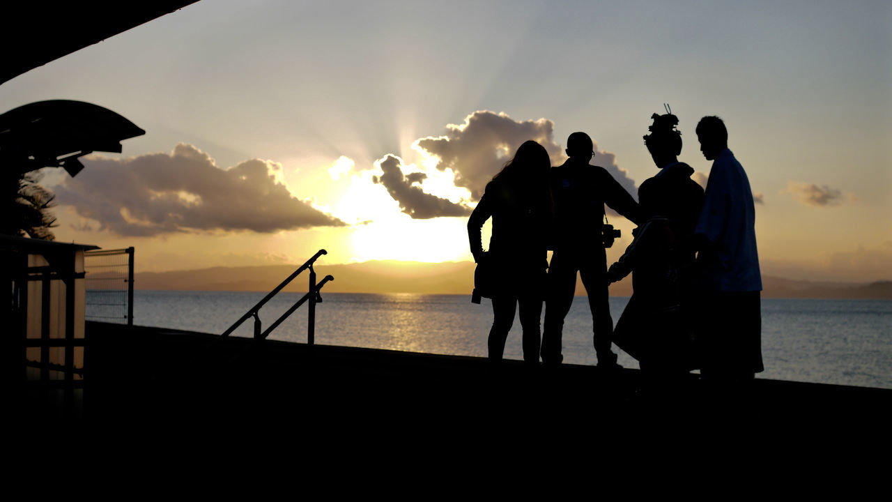 sunset, silhouette, sea, sky, horizon over water, lifestyles, men, leisure activity, sun, person, standing, water, togetherness, orange color, cloud - sky, beach, beauty in nature, nature