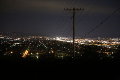 Aerial view of city lit up at night