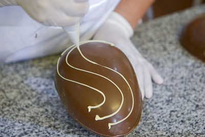 Close-up of hand holding egg chocolate 