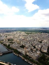 High angle view of river by buildings against sky