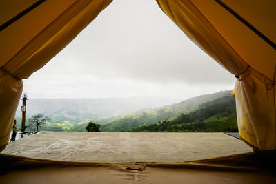 Scenic view of mountains seen through window