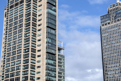 Low angle view of modern buildings in city against sky