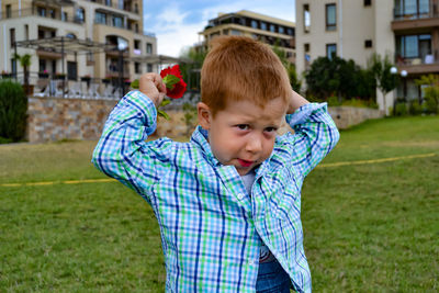 Side view of boy standing on field