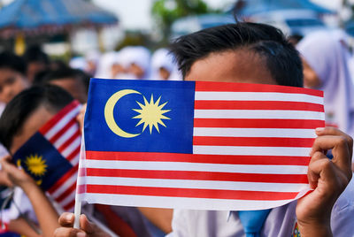 Close-up of boys holding flags