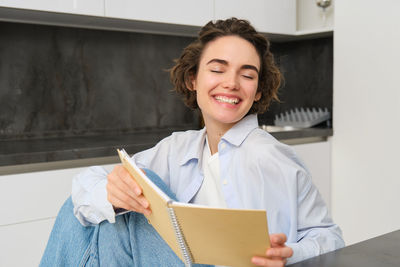 Portrait of young woman using digital tablet