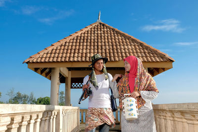 Couple walking on footbridge